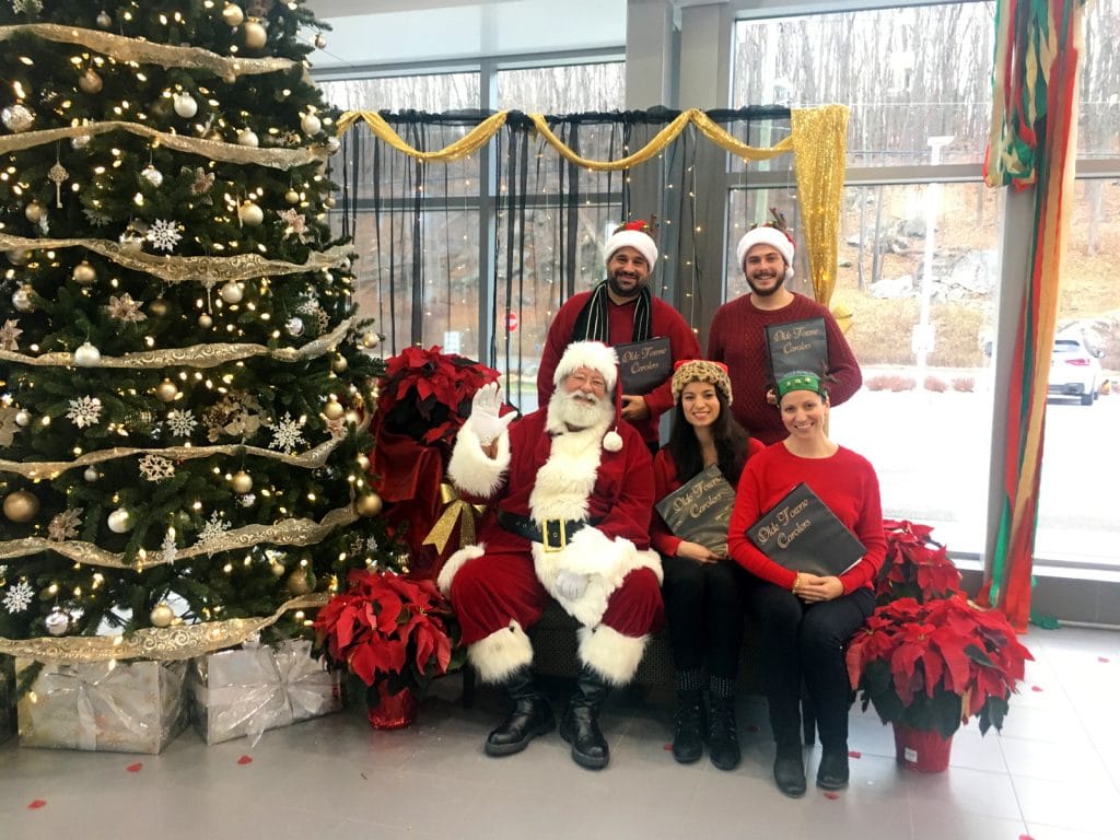 The carolers hang with Santa during a performance for BMW of Ridgefield, CT.