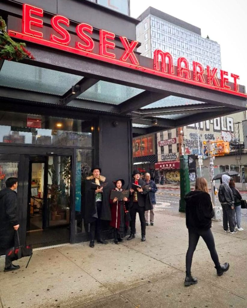Street corner caroling at the Essex Market in New York City.