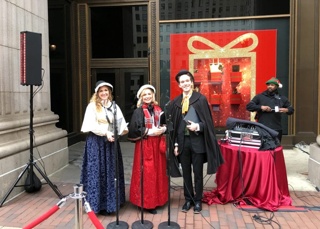 The carolers prepare to sing outside Macy's (the Philly Wanamaker Building) in 2017.